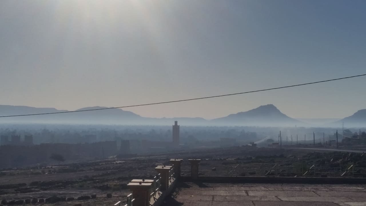 A minaret rising through morning mist at Zagora, in the Draa valley